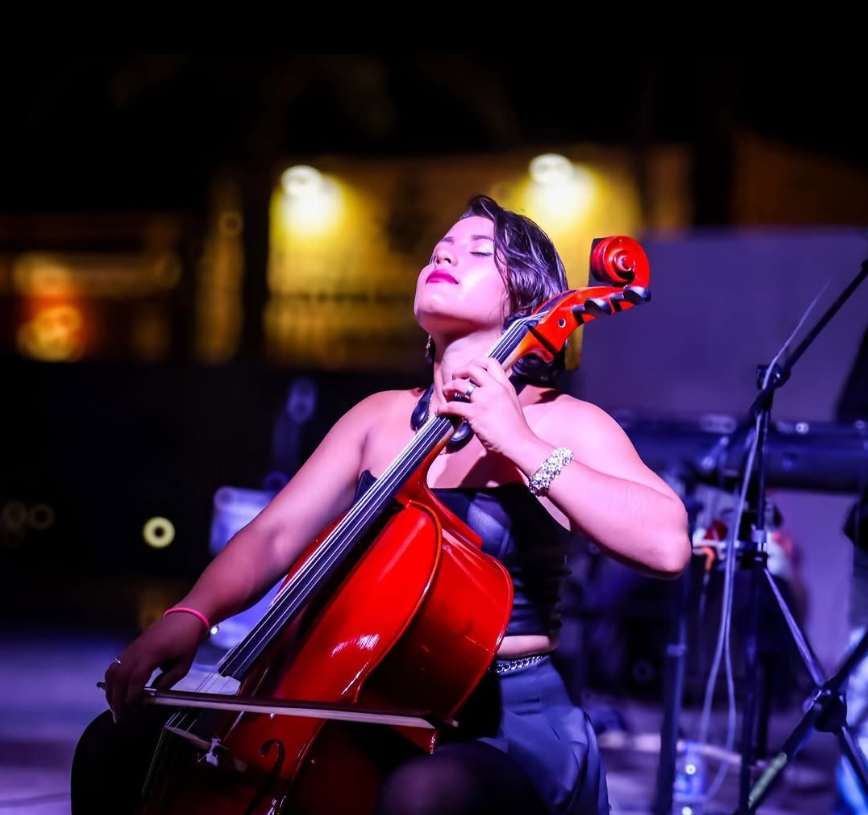 Genessis performing cello at a wedding ceremony in Cabo